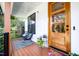 Inviting front porch with rocking chairs, stylish rug, and attractive wooden door with glass inserts at 517 Bart St, Raleigh, NC 27610