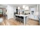 Open-concept kitchen with stainless appliances, bar seating, and stylish pendant lighting at 517 Bart St, Raleigh, NC 27610