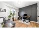 Home office with wood accent wall, natural light, and comfortable seating at 517 Bart St, Raleigh, NC 27610