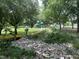 Serene neighborhood playground with slides and swings, surrounded by trees and landscaping at 517 Bart St, Raleigh, NC 27610