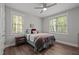 Bright bedroom featuring wood-look floors, a ceiling fan, and two large windows for plenty of natural light at 5402 Shealtiel Way, Rougemont, NC 27572