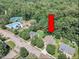 Aerial view of a suburban home with mature trees, close to a pool and tennis courts at 5603 Whisperwood Dr, Durham, NC 27713