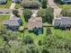 Aerial view of a residential neighborhood with green lawns and mature trees at 5603 Whisperwood Dr, Durham, NC 27713