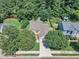 Aerial view of a home with a well-manicured lawn and mature trees at 5603 Whisperwood Dr, Durham, NC 27713