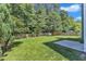 Large, level, grassy backyard with a wooden fence and mature trees for privacy at 5603 Whisperwood Dr, Durham, NC 27713