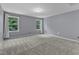 Bedroom with large windows and curtains with carpet flooring at 5603 Whisperwood Dr, Durham, NC 27713