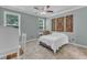 Serene bedroom with tray ceilings, neutral walls, a ceiling fan, and a window view at 5603 Whisperwood Dr, Durham, NC 27713