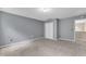 Spacious bedroom with grey walls, and large closet doors at 5603 Whisperwood Dr, Durham, NC 27713
