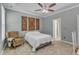 Inviting bedroom with a comfortable armchair, ceiling fan, and decorative wall art at 5603 Whisperwood Dr, Durham, NC 27713