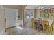 Bright dining area with tiled floor, colorful chairs, and bay window at 5603 Whisperwood Dr, Durham, NC 27713