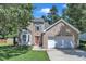 Charming brick two-story home featuring a two-car garage and lush landscaping at 5603 Whisperwood Dr, Durham, NC 27713