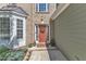 Inviting front entrance with a decorative wreath and colorful potted plants at 5603 Whisperwood Dr, Durham, NC 27713