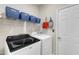 Convenient laundry room with modern washer, dryer, and shelving for storage at 5603 Whisperwood Dr, Durham, NC 27713