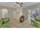 Open-concept living room with tile floors, comfortable seating, and bright lighting at 5603 Whisperwood Dr, Durham, NC 27713