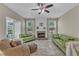 Inviting living room with a brick fireplace, ceiling fan, and comfortable sofas at 5603 Whisperwood Dr, Durham, NC 27713