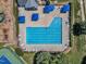 Aerial view of a pool with blue umbrellas, chairs, and a playground nearby at 5603 Whisperwood Dr, Durham, NC 27713