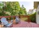 Enjoy the wooded views from the outdoor deck featuring two chairs and a small table at 6004 Solitude Way, Durham, NC 27713