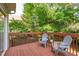 Enjoy the wooded views from the outdoor deck featuring two chairs and a small table at 6004 Solitude Way, Durham, NC 27713