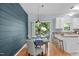 This dining area has a stylish accent wall and is open to the kitchen and exterior deck at 6004 Solitude Way, Durham, NC 27713