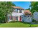 Well-kept two-story home features grey siding, a manicured lawn, and a two-car garage at 6004 Solitude Way, Durham, NC 27713
