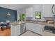 Modern kitchen offers white cabinets, stainless steel appliances, and opens to a dining area at 6004 Solitude Way, Durham, NC 27713