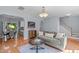 Comfortable living room with grey sofa, modern decor, and open access to dining area at 6004 Solitude Way, Durham, NC 27713