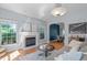 Bright living room boasts a fireplace, ample natural light, and contemporary decor at 6004 Solitude Way, Durham, NC 27713