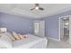A relaxing bedroom featuring an ensuite bathroom, white bedding, and pastel accents at 6004 Solitude Way, Durham, NC 27713