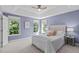 This main bedroom has a neutral color palette and three large windows at 6004 Solitude Way, Durham, NC 27713