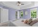 Beautiful bedroom featuring a tray ceiling, a ceiling fan, and an ensuite bathroom at 6004 Solitude Way, Durham, NC 27713
