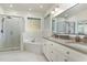 Bright bathroom with a glass shower, a separate tub, and a double sink at 6313 Belle Crest Dr, Raleigh, NC 27612