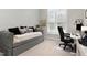 A charming bedroom with a unique brick accent wall, a daybed and a work area at 6313 Belle Crest Dr, Raleigh, NC 27612