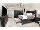 Spacious bedroom featuring a ceiling fan, a large bed, and dark wood furniture at 6313 Belle Crest Dr, Raleigh, NC 27612
