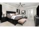 Large bedroom with a ceiling fan, bedside tables, and a light-colored carpet at 6313 Belle Crest Dr, Raleigh, NC 27612