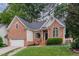 Attractive brick home with a lush lawn and inviting front entrance at 6313 Belle Crest Dr, Raleigh, NC 27612