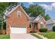 Beautiful brick home with manicured lawn, lovely landscaping and attached garage at 6313 Belle Crest Dr, Raleigh, NC 27612