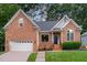 Charming brick home with a well-manicured lawn and inviting entrance at 6313 Belle Crest Dr, Raleigh, NC 27612