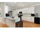 Modern kitchen featuring granite countertops, stainless steel appliances, and ample cabinet space at 6313 Belle Crest Dr, Raleigh, NC 27612