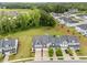 An aerial view of a vibrant neighborhood with lush landscaping, showcasing a community of modern homes at 640 Barneswyck Dr, Fuquay Varina, NC 27526