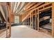 Attic view featuring exposed wooden beams, a window, and insulation, showcasing potential for future living space at 640 Barneswyck Dr, Fuquay Varina, NC 27526