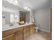 Bathroom featuring double sink vanity, a large mirror, and tile flooring at 640 Barneswyck Dr, Fuquay Varina, NC 27526