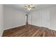 Bedroom features a ceiling fan, hardwood floors, and a double door closet at 640 Barneswyck Dr, Fuquay Varina, NC 27526