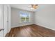 Bedroom with a ceiling fan, hardwood floors, and natural light from a window at 640 Barneswyck Dr, Fuquay Varina, NC 27526