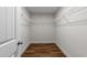 Walk-in closet with wood-look flooring and wire shelving for storage at 640 Barneswyck Dr, Fuquay Varina, NC 27526