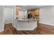 Bright kitchen featuring granite countertops, wood cabinets, stainless steel appliances, and stylish wood flooring at 640 Barneswyck Dr, Fuquay Varina, NC 27526