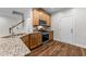 Modern kitchen boasts stainless steel appliances, wood cabinets, granite countertops, and wood flooring at 640 Barneswyck Dr, Fuquay Varina, NC 27526