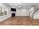 Spacious living room featuring hardwood floors, a fireplace, and a staircase at 640 Barneswyck Dr, Fuquay Varina, NC 27526