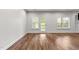 Open-concept living room with hardwood floors and access to the outdoors at 640 Barneswyck Dr, Fuquay Varina, NC 27526