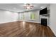 Open living room featuring hardwood floors, a fireplace, and a ceiling fan at 640 Barneswyck Dr, Fuquay Varina, NC 27526