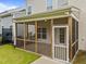 A cozy, screened porch with a wooden railing, seamlessly connected to the house and backyard at 640 Barneswyck Dr, Fuquay Varina, NC 27526